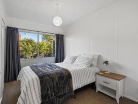 A bedroom with a bed and nightstand at Taupo - Holiday Home