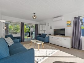A living room with a sofa and television at Taupo - Holiday Home
