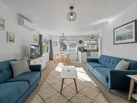 A living room with sofas and a dining area at Taupo - Holiday Home