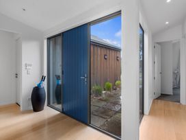 An entrance hall with a blue front door and an umbrella stand at Omaha in Omaha