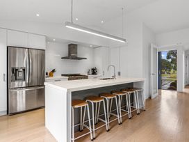 A kitchen with a countertop and stools at Omaha in Omaha