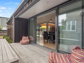 An outdoor area with sliding glass doors leading to a dining area at White Sands Haven - Omaha
