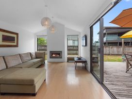 A living room with a fireplace and television at White Sands Haven - Omaha