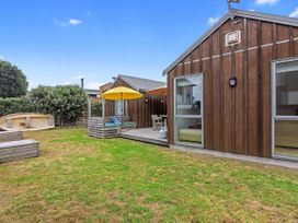 An outdoor area with a deck and garden at White Sands Haven - Omaha