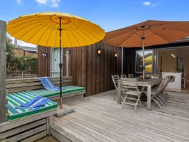 An outdoor seating area with umbrellas and a table at White Sands Haven - Omaha