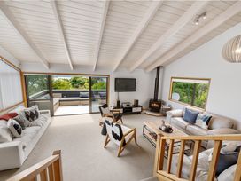 A living room with a sofa and television at Paihia in Paihia