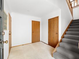An entrance hall with doors and a staircase at Paihia