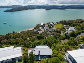 An aerial view of houses and water with trees in Paihia, Paihia