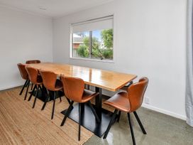 A dining room with a table and chairs at Ruakaka Coastal Reserve Retreat Ruakaka