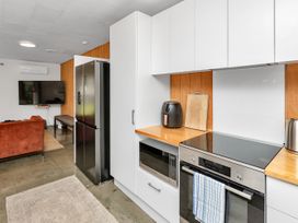 A kitchen with appliances and countertop at Ruakaka Coastal Reserve Retreat Ruakaka