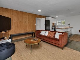A living room with a sofa and coffee table at Ruakaka Coastal Reserve Retreat Ruakaka