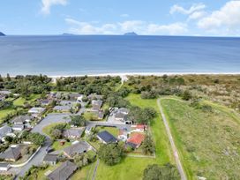 Aerial view of houses near the beach at Ruakaka Coastal Reserve Retreat in Ruakaka