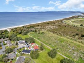 An aerial view of houses by the beach at Ruakaka Coastal Reserve Retreat in Ruakaka