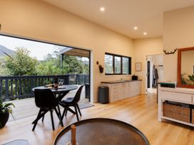 A kitchen with dining area and wine setup at Hidden Springs Mountain View Waihi