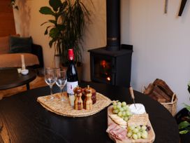 A living room with wine, cheese, and snacks at Hidden Springs Mountain View Waihi