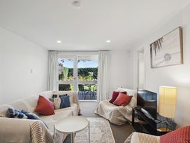 A living room with sofas and a TV at Wanaka Holiday Home in Wanaka