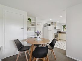 A kitchen with dining table and chairs at Wanaka Holiday Home in Wanaka