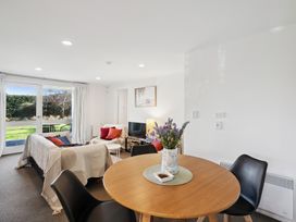 A living room with a sofa, table and television at Wanaka Holiday Home in Wanaka