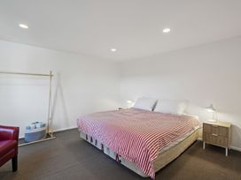 A bedroom with a bed and bedside table at Wanaka Holiday Home in Wanaka