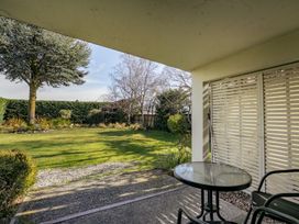 A garden with a table and chair at Wanaka Holiday Home in Wanaka