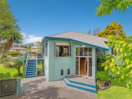 A house with stairs and a garden at Whangamata