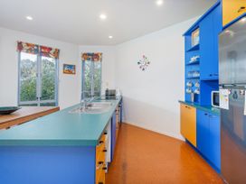 A kitchen with a sink and cabinets at Whangamata