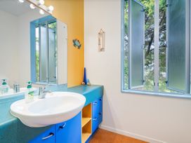 A bathroom with a sink and window at Whangamata