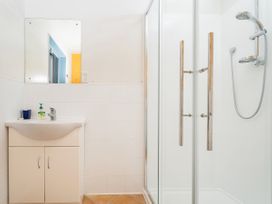 A bathroom featuring a sink and a shower at Whangamata