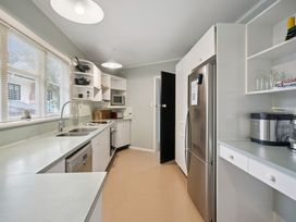 A kitchen with appliances and countertops at Khandallah Stays - Wellington