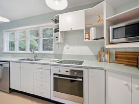 A kitchen with sink, oven, microwave and stove at Khandallah Stays - Wellington