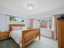 A bedroom with a bed and bedside table at Khandallah Stays - Wellington