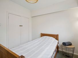 A bedroom with a bed and a closet at Khandallah Stays - Wellington Holiday home Wellington