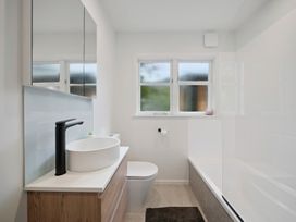 A bathroom with a wash basin and toilet at Khandallah Stays - Wellington Holiday home Wellington