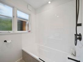 A bathroom with a bathtub and shower at Khandallah Stays - Wellington Holiday home Wellington