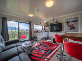 A living room with a television and sofa at Ducati House - Te anau Holiday Home