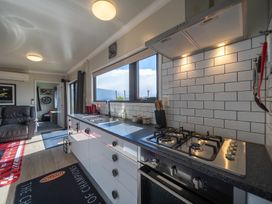 A kitchen with a stove and sink at Ducati House - Te anau Holiday Home