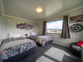 A bedroom with two beds and a window at Ducati House - Te anau Holiday Home