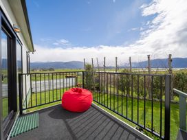 A balcony with a bean bag overlooking mountains at Ducati House - Te anau Holiday Home