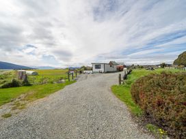 A house with a gravel driveway at Ducati House - Te anau Holiday Home