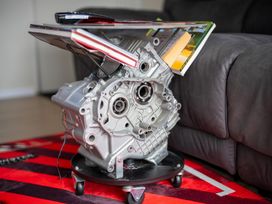 A coffee table made from an engine with magazines at Ducati House - Te anau Holiday Home