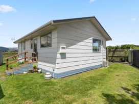 An exterior view of a house with steps and garden at Kapiti Breeze - Waikanae Beach Holiday Home