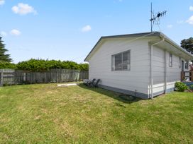 A house with outdoor furniture in the garden at Kapiti Breeze - Waikanae Beach Holiday Home