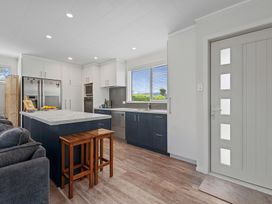A kitchen with cabinets and an island at Rotorua Holiday Home in Rotorua
