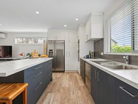 A kitchen with an island and appliances at Rotorua Holiday Home in Rotorua