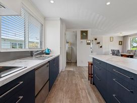 A kitchen with a sink and stove at Rotorua Holiday Home in Rotorua