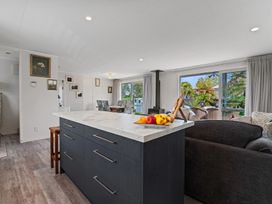 A kitchen with a dining area and a view at Rotorua Holiday Home in Rotorua