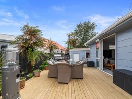 An outdoor area with seating and a barbecue grill at Rotorua Holiday Home in Rotorua