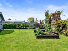 A garden with raised beds and a clothesline at Rotorua Holiday Home in Rotorua