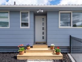 An entrance with steps and planters at Rotorua Holiday Home in Rotorua