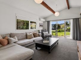 A living room with a sofa and coffee table at Lake Okareka Holiday Home in Rotorua